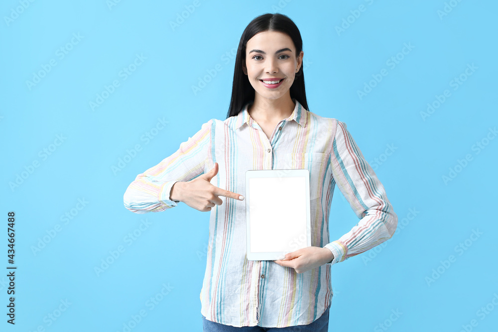 Beautiful young woman with tablet computer on color background Beautiful young woman with tablet computer on color background