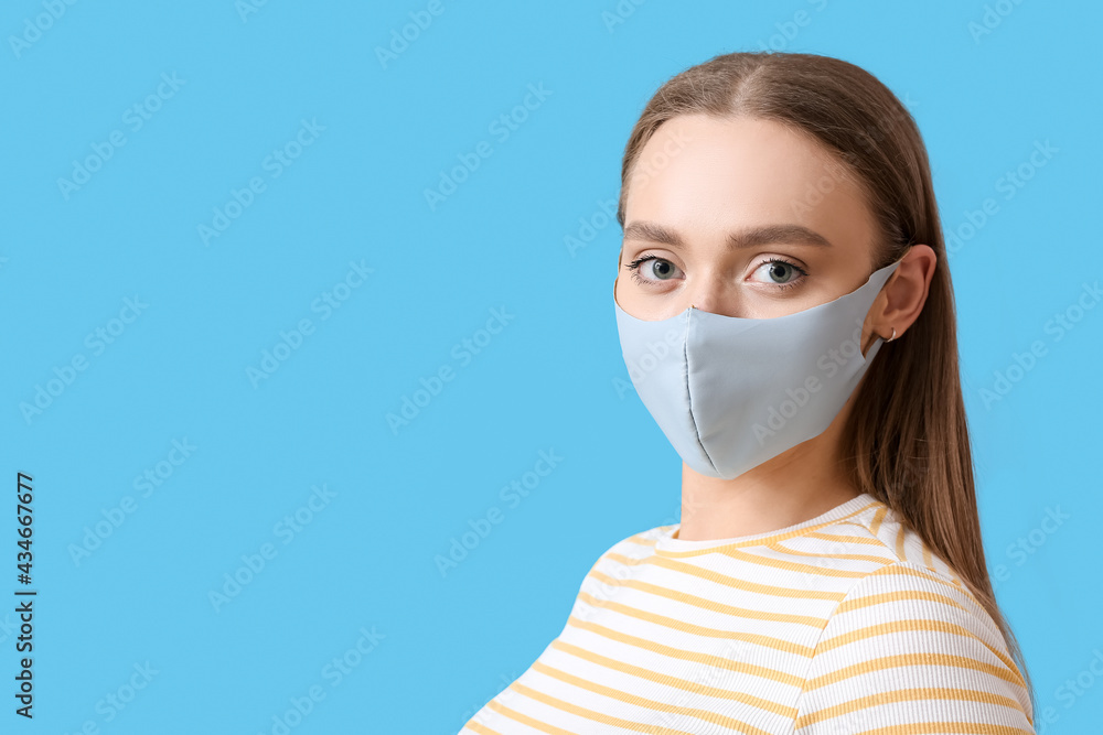 Stylish young woman wearing mask on color background Stylish young woman wearing mask on color background