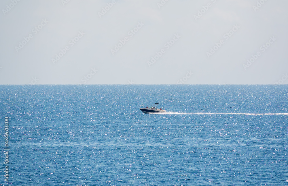 Naklejka premium Motor boat in the blue calm sea.
