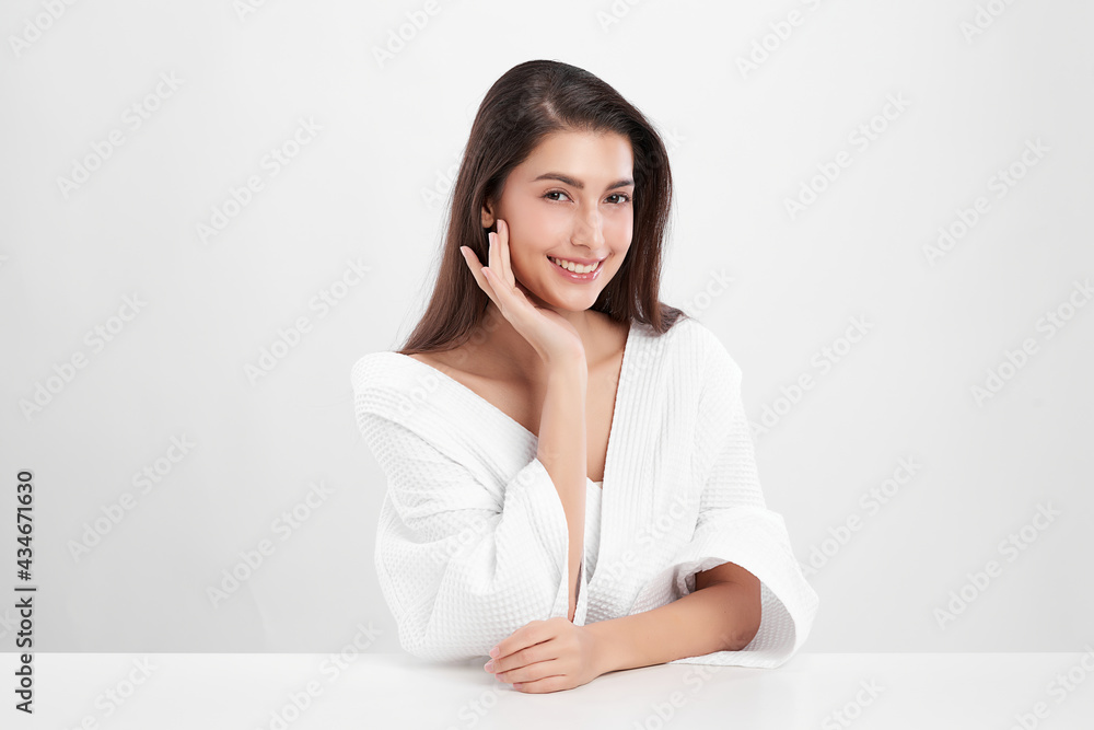 Beautiful young Asian woman wearing bathrobe on white background, Face care, Facial treatment, Cosmetology, beauty and spa Concept. Beautiful young Asian woman wearing bathrobe on white background, Face care, Facial treatment, Cosmetology, beauty and spa Concept.