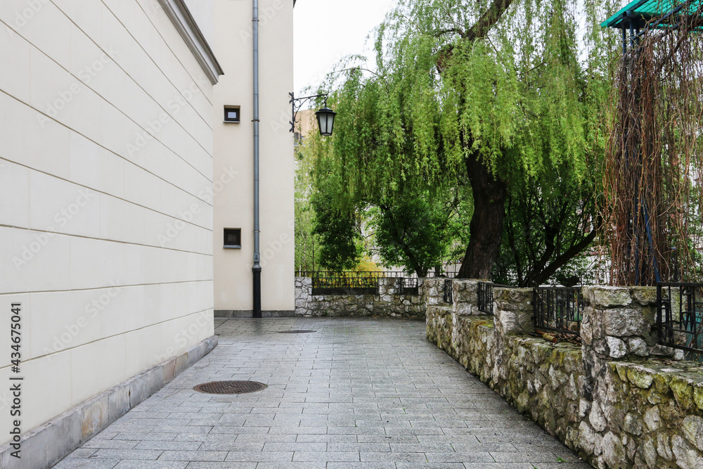 KRAKOW, POLAND - MAY 05, 2021: Outdoor passageway between two tenement houses in the old town KRAKOW, POLAND - MAY 05, 2021: Outdoor passageway between two tenement houses in the old town