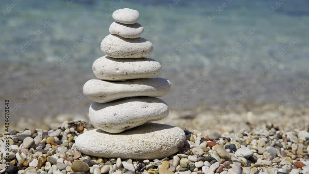 Zen meditation background - balanced stones stack cairn close up on sea beach. Zen meditation background - balanced stones stack cairn close up on sea beach.