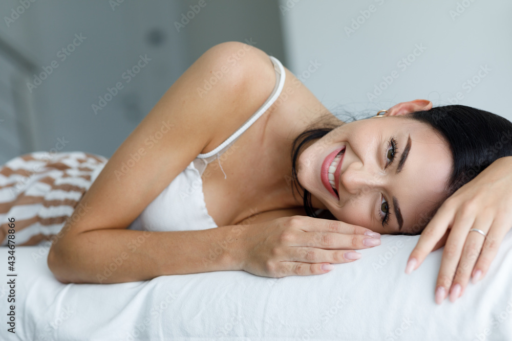 Attractive dark haired young woman with a sweet smile Attractive dark haired young woman with a sweet smile