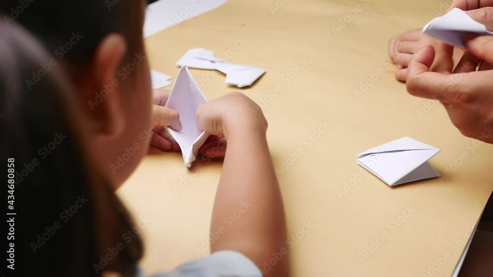 Mother and children learning about The Japanese art of folding paper