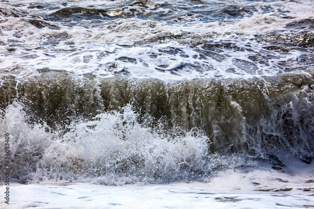 Splashing big waves on the seashore.