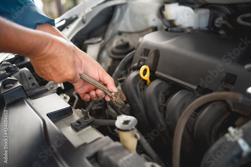 Car service and maintenance concept Photos of a young auto mechanic repair car problems. © PBXStudio