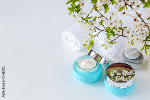 Cosmetic cream in blue glass jars. Natural spa cosmetics. copy space