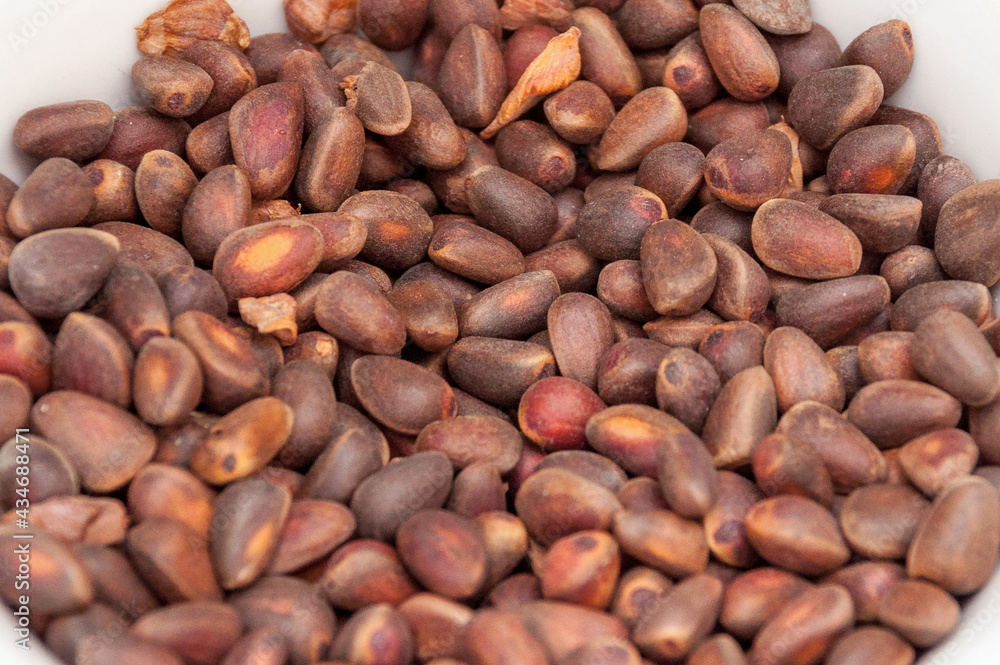 A pile of roasted coffee beans, rough brown in color A pile of roasted coffee beans, rough brown in color