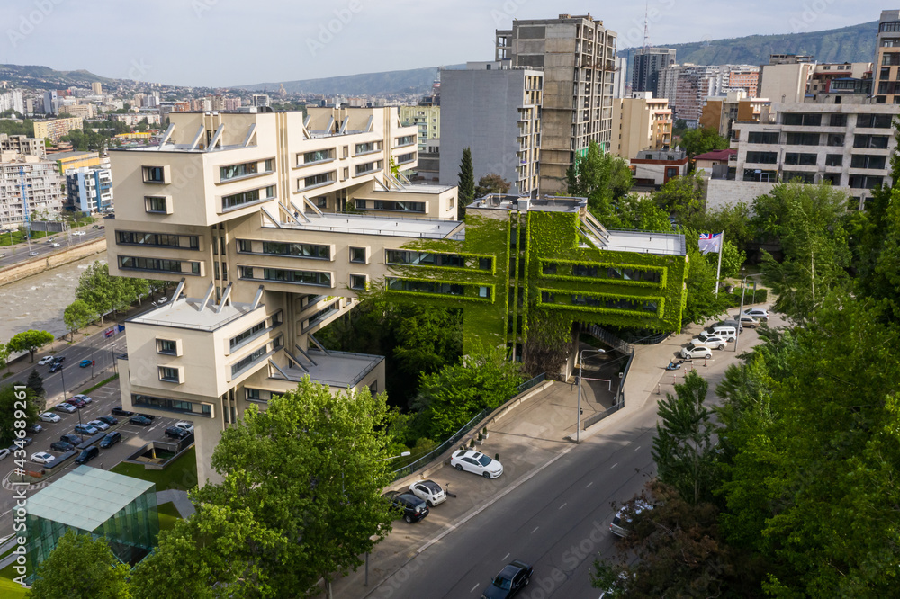 Fototapeta premium Tbilisi, Georgia. Building of Bank of Georgia headquarters ex for the Ministry of Highway. Beautiful Soviet constructivists, Brutalist and Structuralism. Aerial drone photo from above