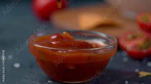 Hand dipping Tortillas chips in salsa sauce