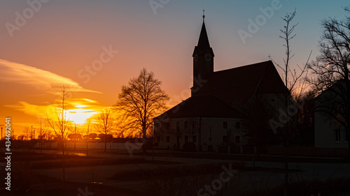 Beautiful sunset with a church silhouette near Kurzenisarhofen, Bavaria, Germany