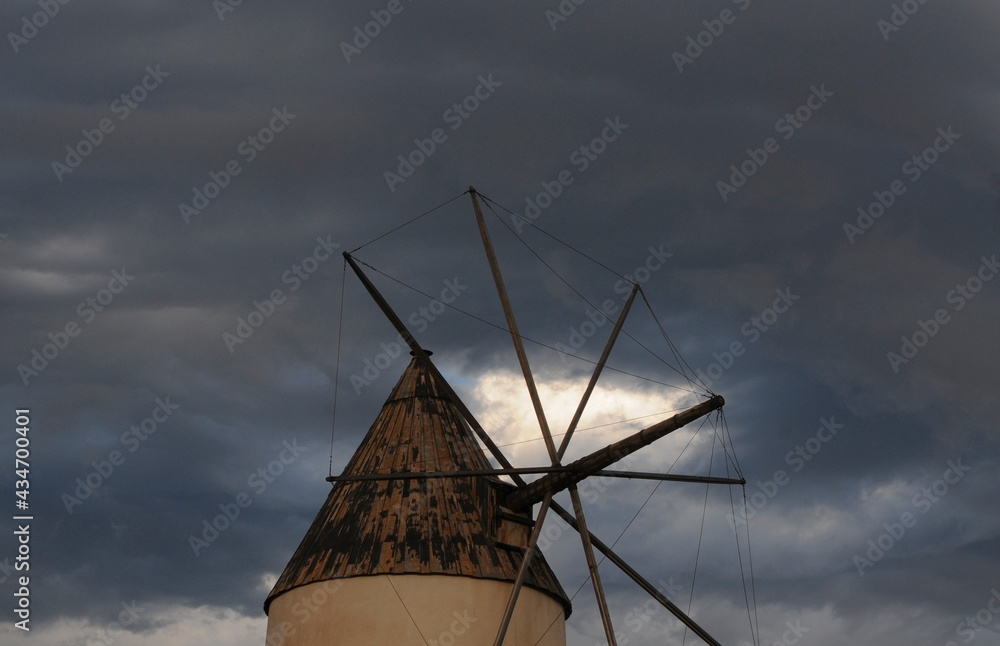 Windmill of the Cabo de Gata nature park, Spain, with cloudy sky.