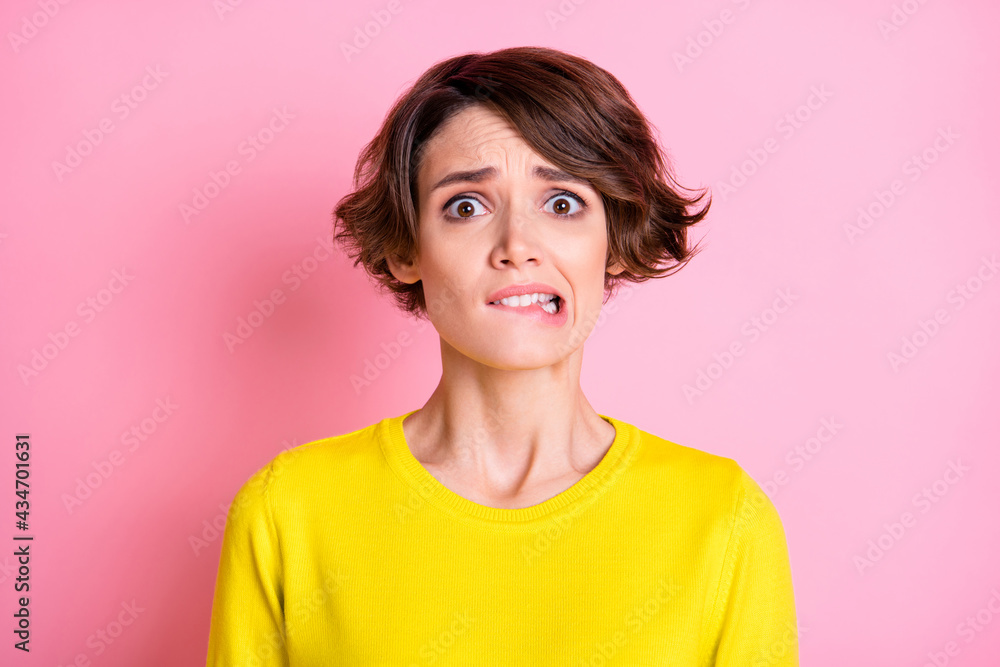 Portrait of attractive funny miserable nervous brown-haired girl biting lip isolated over pink pastel color background Portrait of attractive funny miserable nervous brown-haired girl biting lip isolated over pink pastel color background