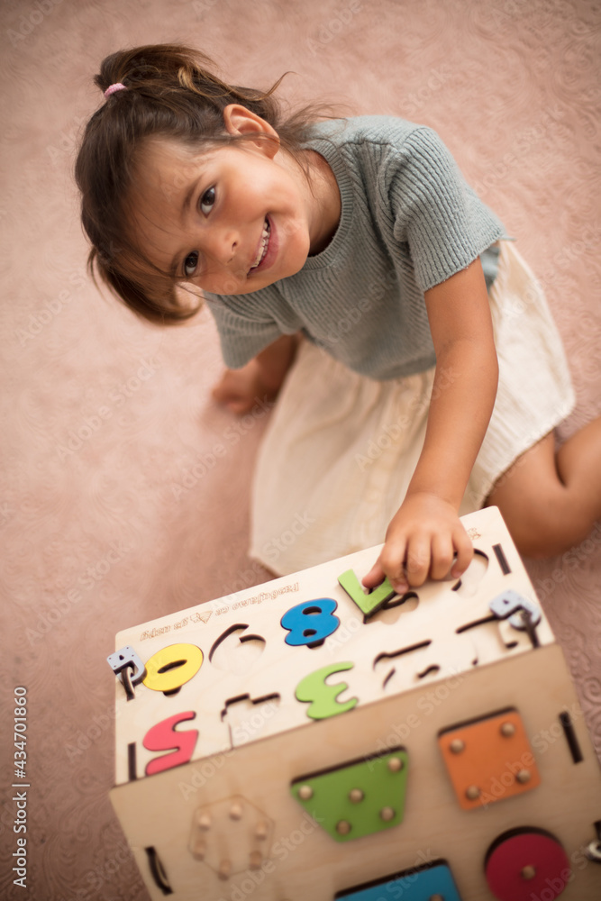 Toddler playing interactive games for good development at home.