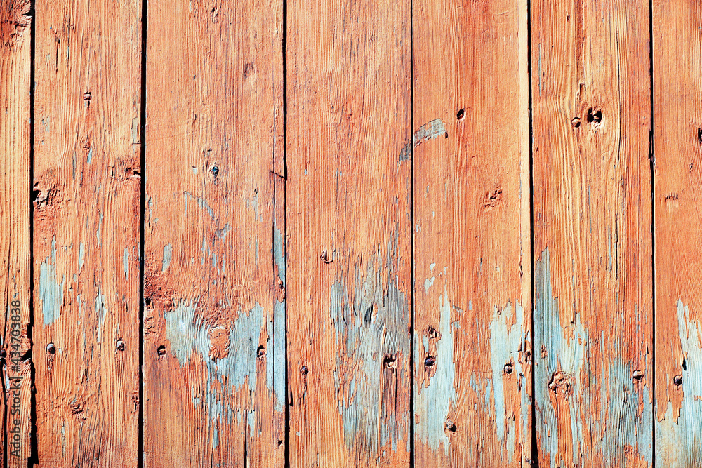 Texture of an old wooden wall with peeling red paint. Vintage background from boards Texture of an old wooden wall with peeling red paint. Vintage background from boards