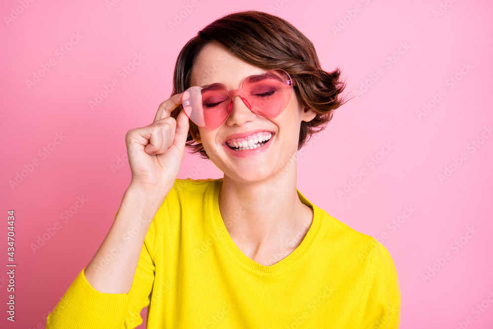 Photo portrait of happy girl wearing heart shaped glasses laughing overjoyed isolated on pastel pink color background
