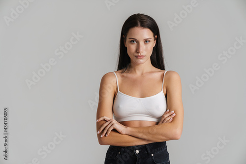 Young brunette woman wearing brassiere posing and looking at camera