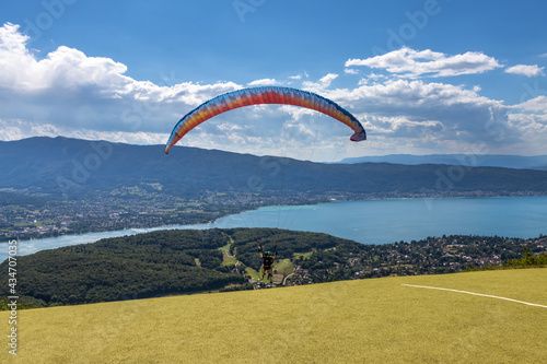 People paragliding in Talloires near lake Annecy.