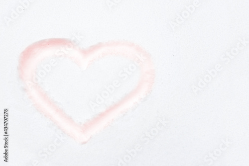Red heart shape drawing on white snow as love valentine background