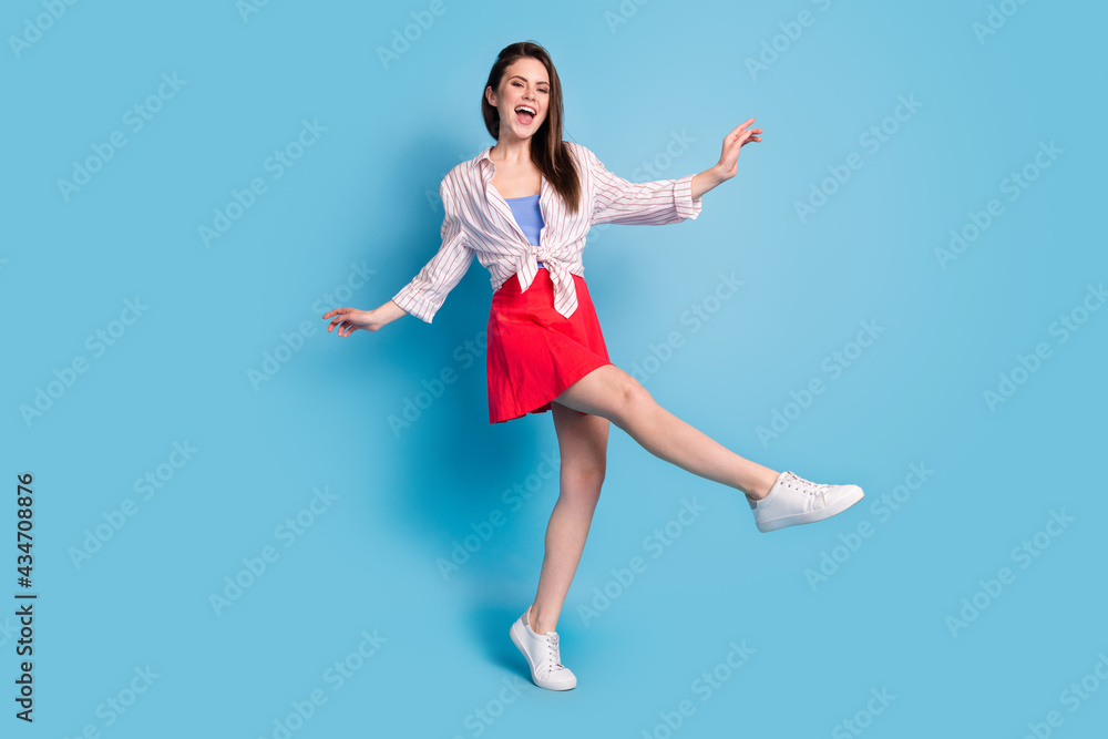Full length body size view of attractive cheerful carefree girl dancing clubbing isolated over bright blue color background