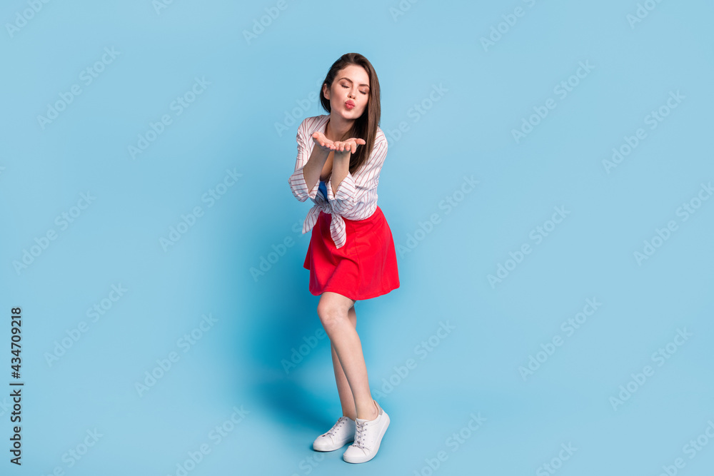 Full length body size view of attractive slim amorous affectionate dreamy girl sending air kiss isolated over bright blue color background