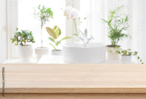 Blank tabletop for product display with blurred bathroom sink background