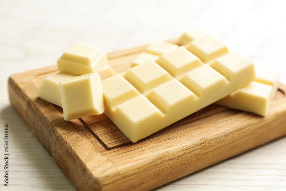 Delicious white chocolate on wooden table, closeup
