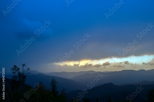 bright sunrise in the mountains with blue sky