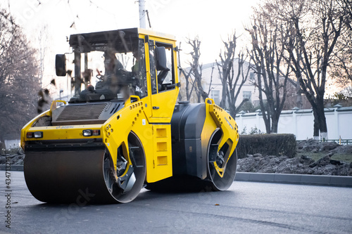 Road repair. Asphalt and concrete roller