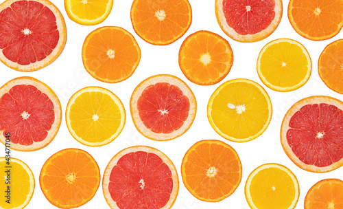 Bright fruit citrus background. Summer background. Oranges, grapefruits and tangerines isolated on white surface.
