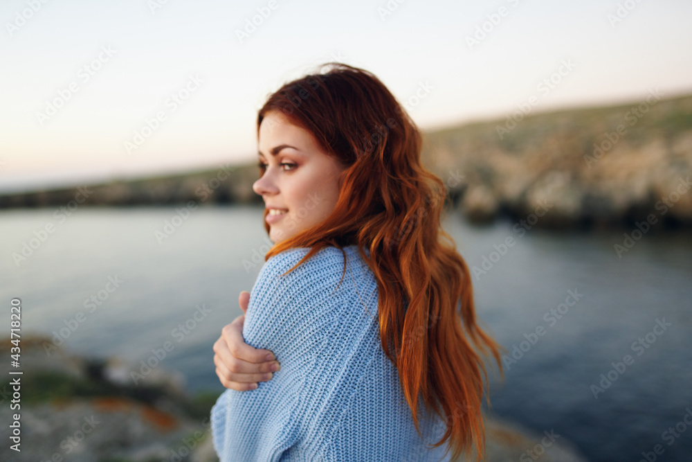 pretty red-haired woman in sweater outdoors rocky mountains vacation pretty red-haired woman in sweater outdoors rocky mountains vacation
