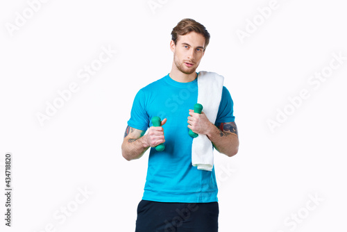 sporty man in blue t-shirt towel on shoulders workout fitness