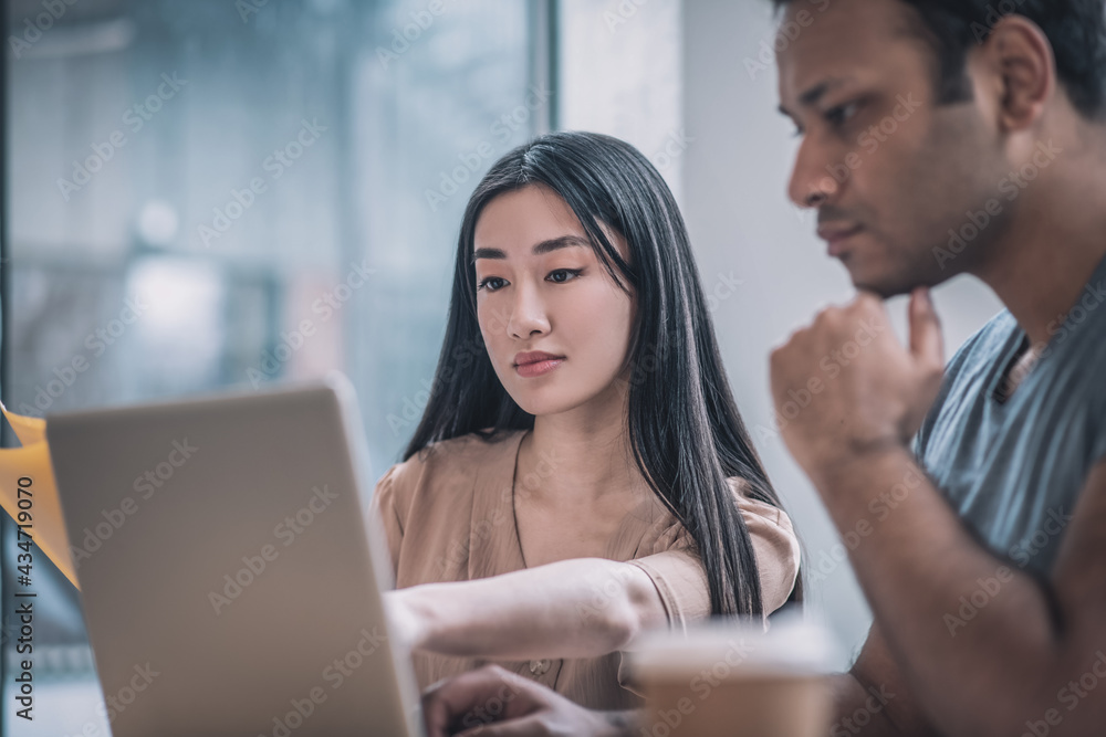 Colleagues working in the office and looking concentrated