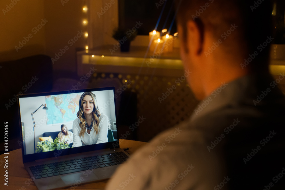 Man talking with his wife in video chat at night. Time differences between time zones. Man talking with his wife in video chat at night. Time differences between time zones.
