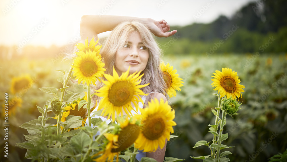 Young woman in sunflower field enjoying nature Young woman in sunflower field enjoying nature