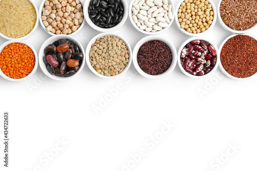Various raw veggie seeds in bowls on white background, top view