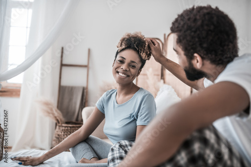 African american touching head of happy wife