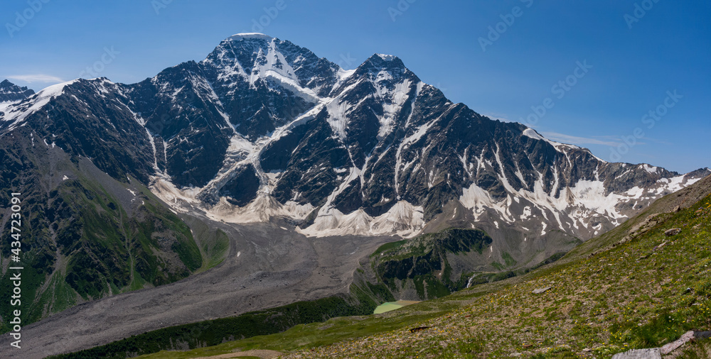 Panoramic view of Glacier Seven on mount Donguzorun. Panoramic view from Cheget mount, Kabardino Balkaria region. Russia. 3000 metres height. Lifting on Cable Car. View on Donguzorun peak on left and - obrazy, fototapety, plakaty 