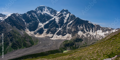 Panoramic view of Glacier Seven on mount Donguzorun. Panoramic view from Cheget mount, Kabardino Balkaria region. Russia. 3000 metres height. Lifting on Cable Car. View on Donguzorun peak on left and © Roman Mishchenko