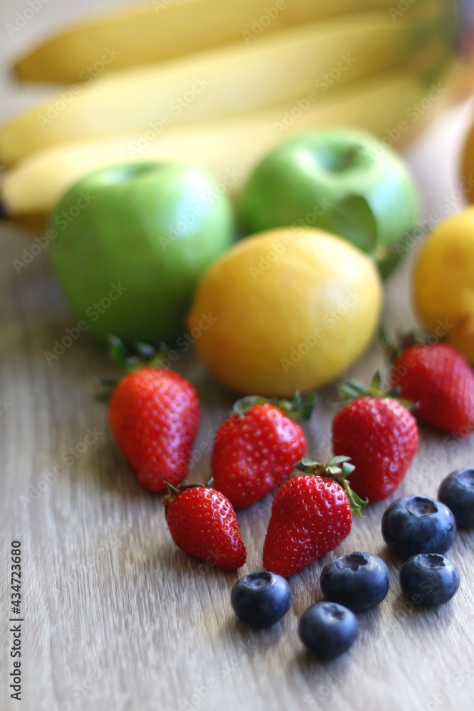 Various colorful fruit on wooden background. Selective focus. Various colorful fruit on wooden background. Selective focus.