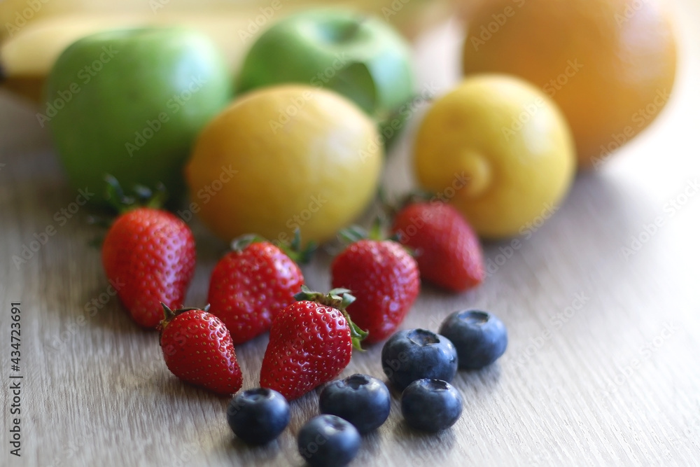 Various colorful fruit on wooden background. Selective focus. Various colorful fruit on wooden background. Selective focus.
