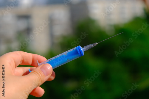 syringe on a green background