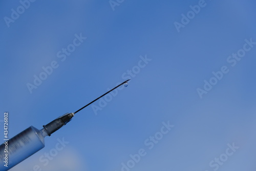 syringe on blue background