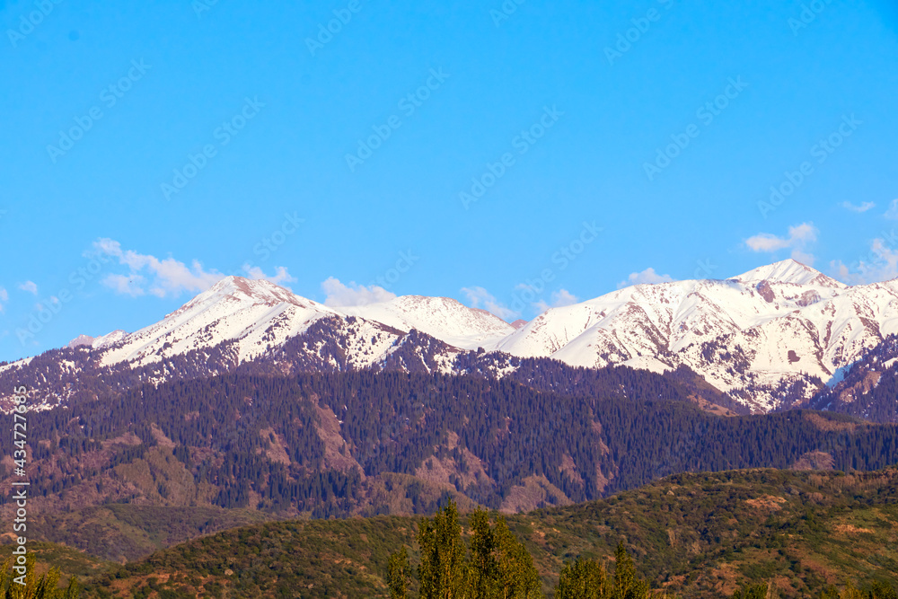 view of the snow-capped mountains landscape with blue sky