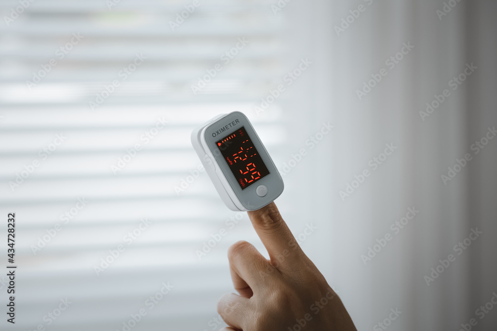 closeup old woman's hand for self blood oxygen monitoring closeup old woman's hand for self blood oxygen monitoring