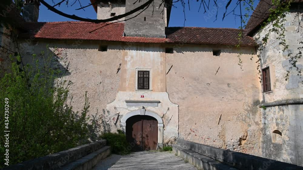 Gracar Turn castle in Slovenia. View of entrance bridge. Beautiful and historic building. 14th century historic castle backyard walls. Wide angle, tilt up Gracar Turn castle in Slovenia. View of entrance bridge. Beautiful and historic building. 14th century historic castle backyard walls. Wide angle, tilt up