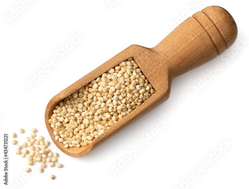 raw white quinoa in the wooden scoop, isolated on white background, top view