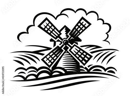 Windmill among hills and fields with clouds