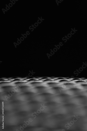 Metal grille details on black background.