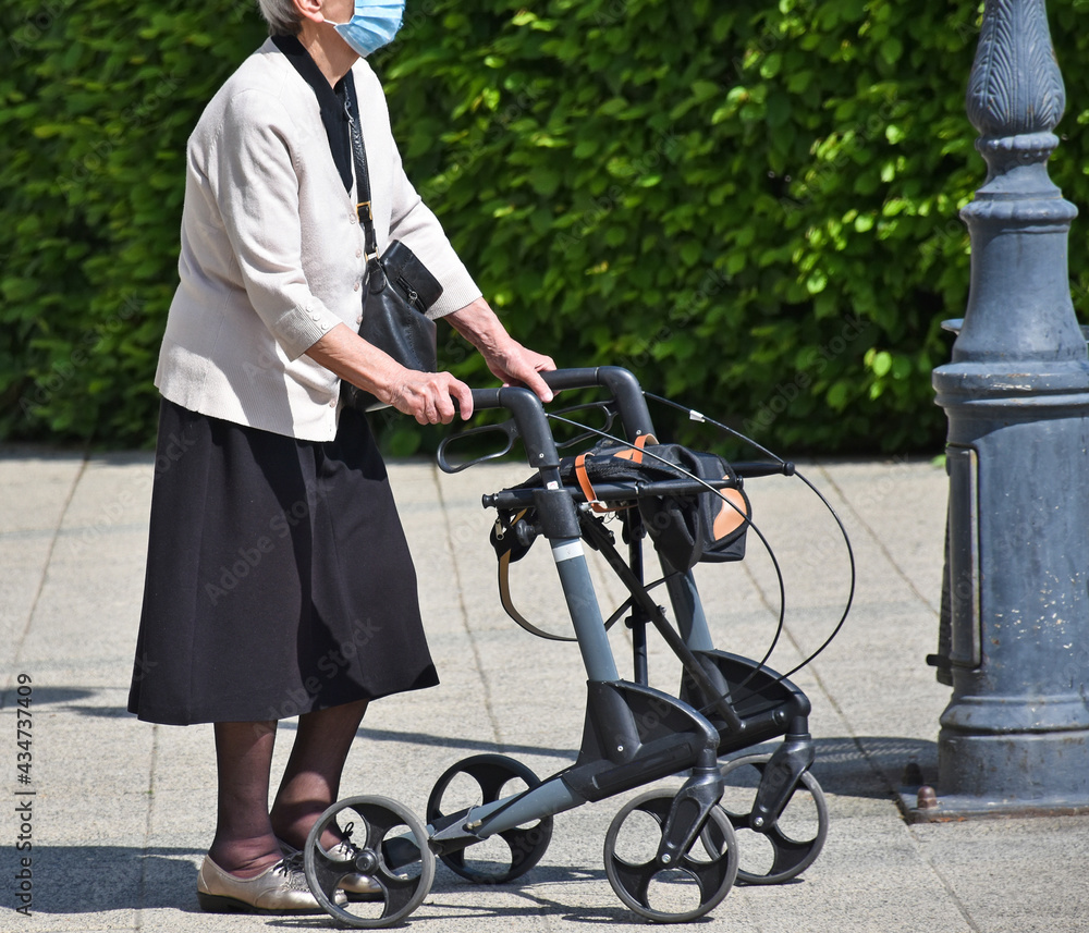 Senior woman on the street with a walker Senior woman on the street with a walker